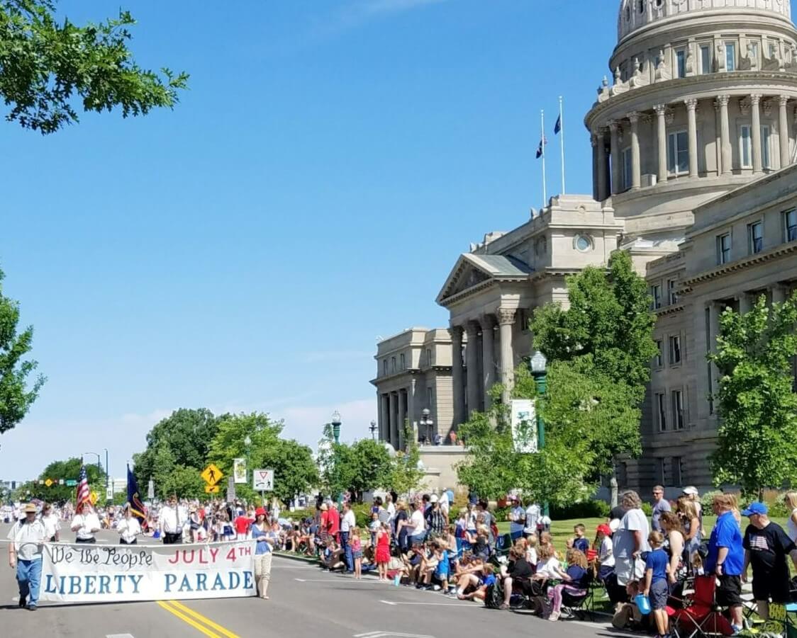 Crowd of people watching the Boise 4th of July Independence Day Parade in front of the Boise capitol building downtown