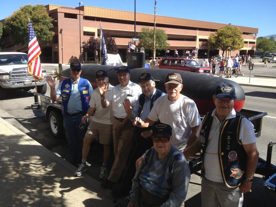 Veterans posing in front of a historic submarine at the Boise 4th of July parade
